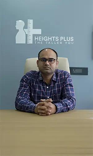 Front view of Dr. Navish Kumar Vinod sitting down a hospital chair