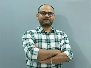 Dr. Navish Kumar Vinod sitting on a chair